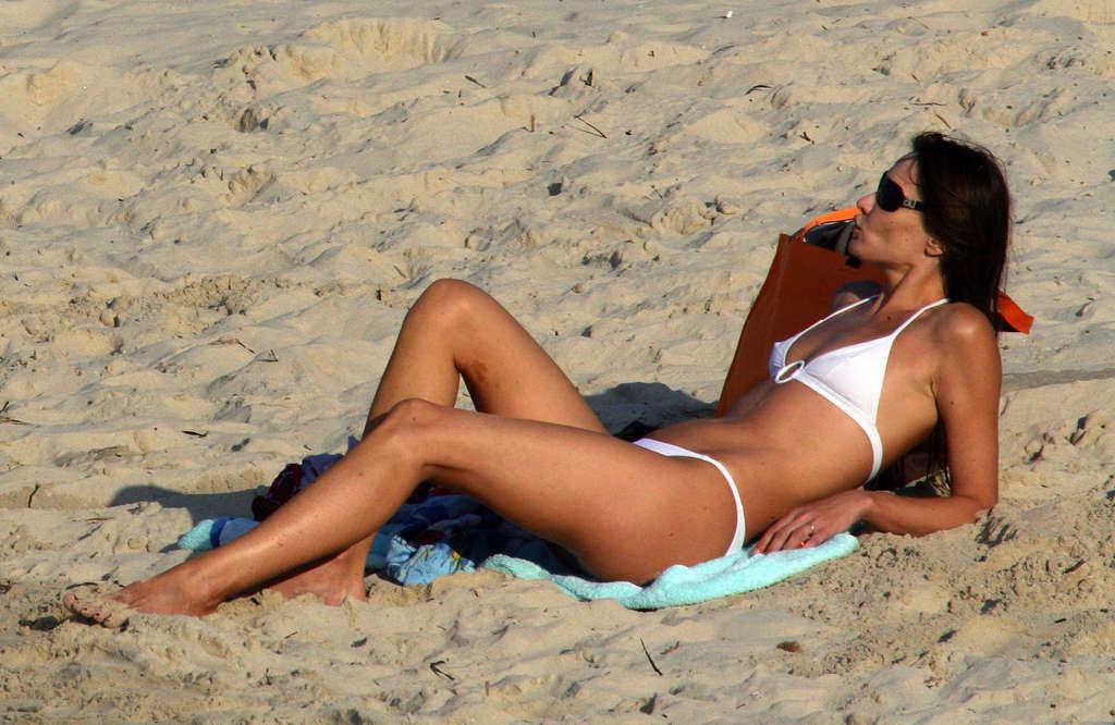 10P Carla Bruni exposing her nice tits and pookies in bikini paparazzi pictures