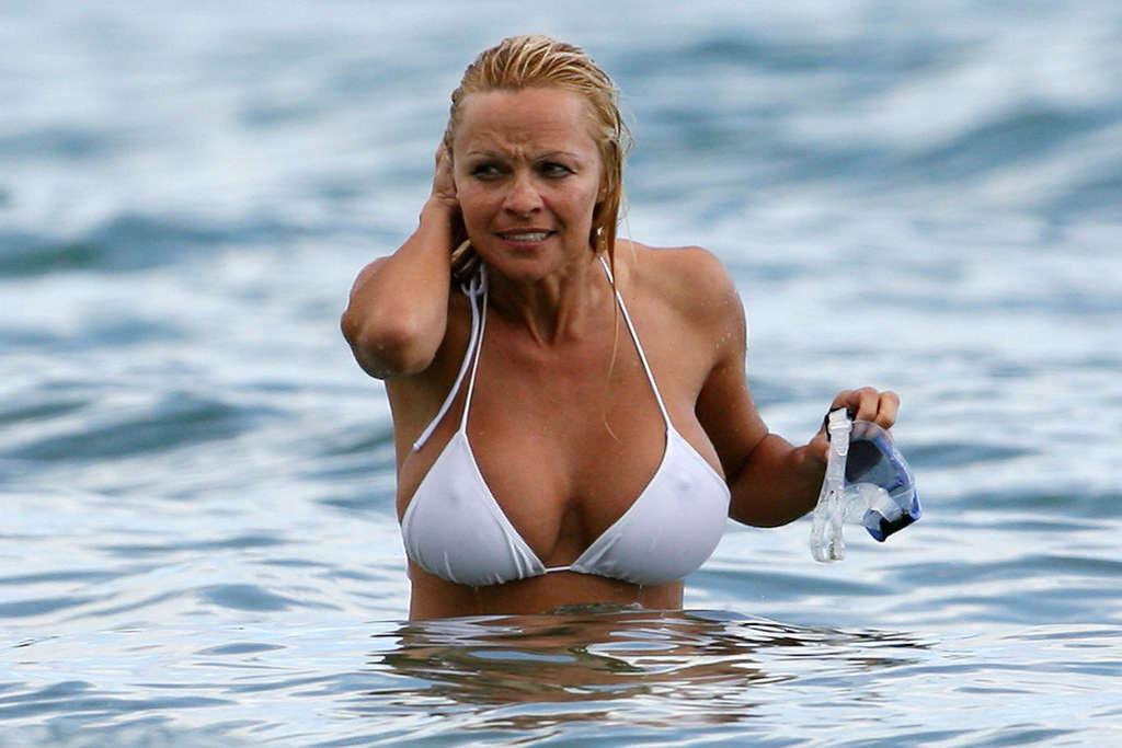 16P Pamela Anderson posing on beach and showing her nice body and sexy ass very hot 