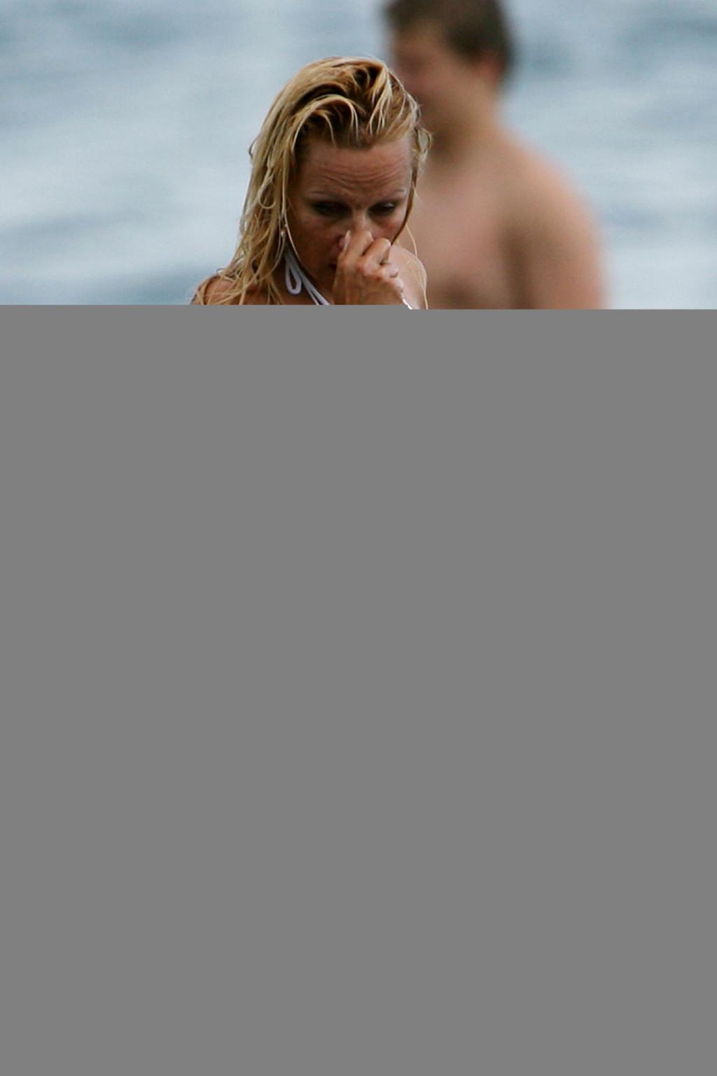 16P Pamela Anderson posing on beach and showing her nice body and sexy ass very hot 