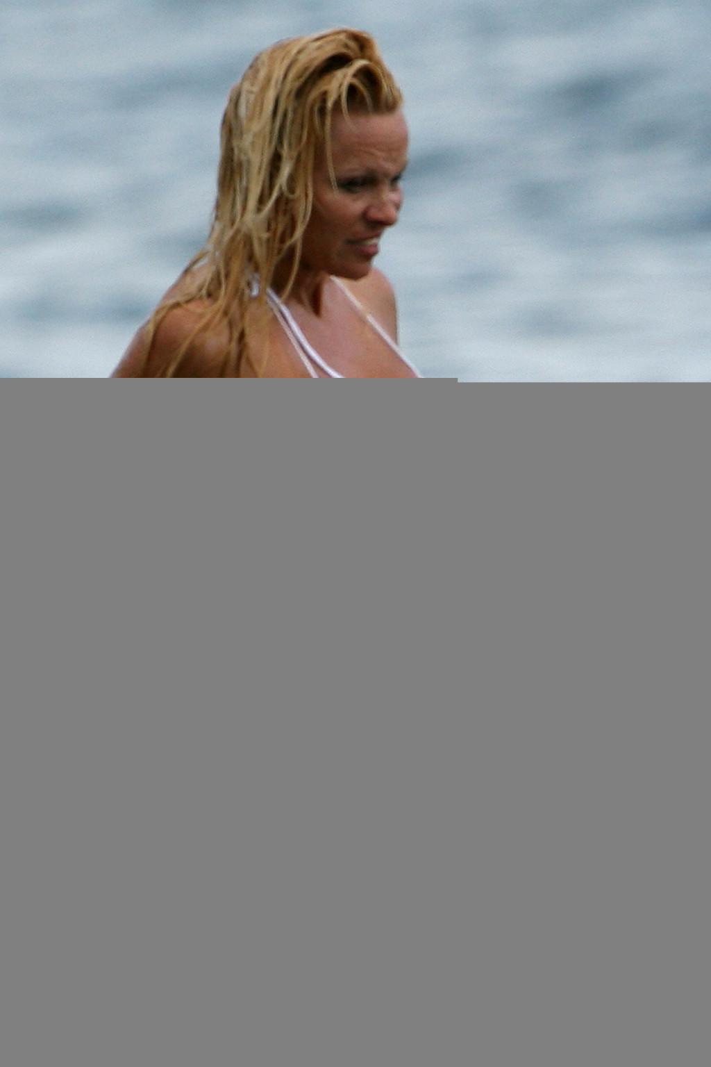 16P Pamela Anderson posing on beach and showing her nice body and sexy ass very hot 