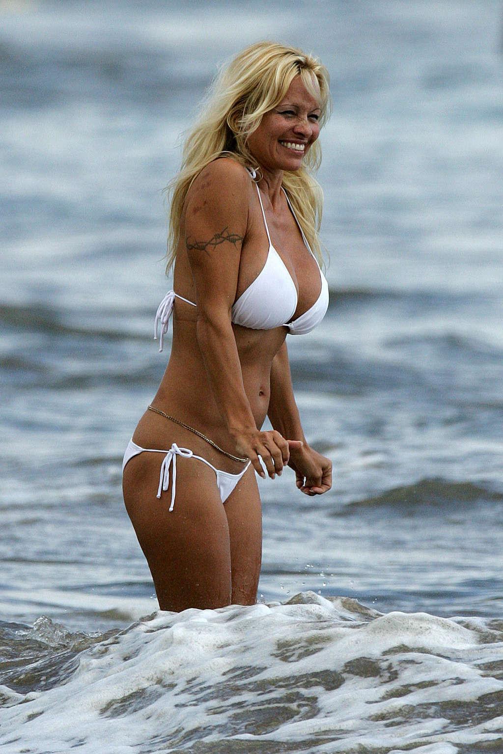 16P Pamela Anderson posing on beach and showing her nice body and sexy ass very hot 