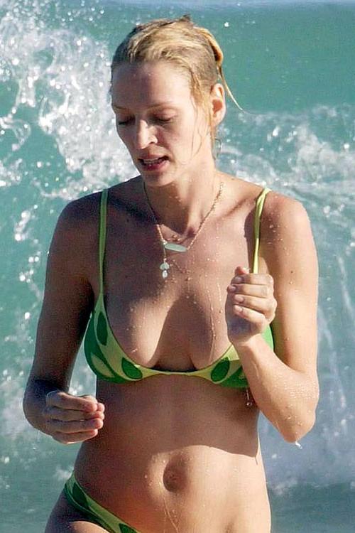 16P Uma Thurman showing her nice big tits on beach and posing in bikini