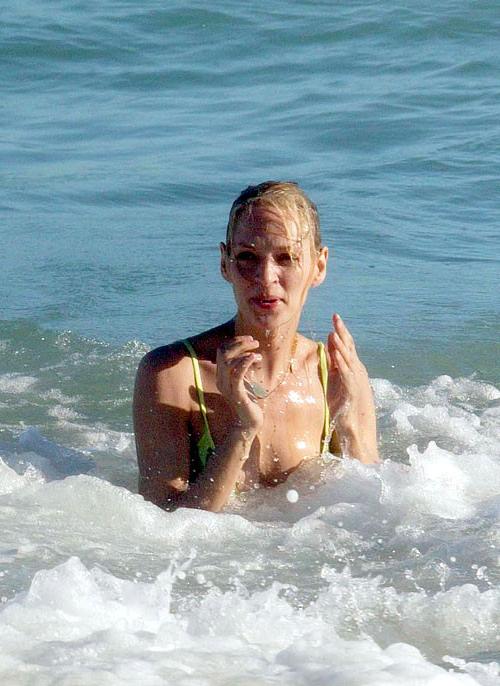 16P Uma Thurman showing her nice big tits on beach and posing in bikini