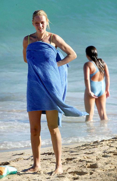 16P Uma Thurman showing her nice big tits on beach and posing in bikini