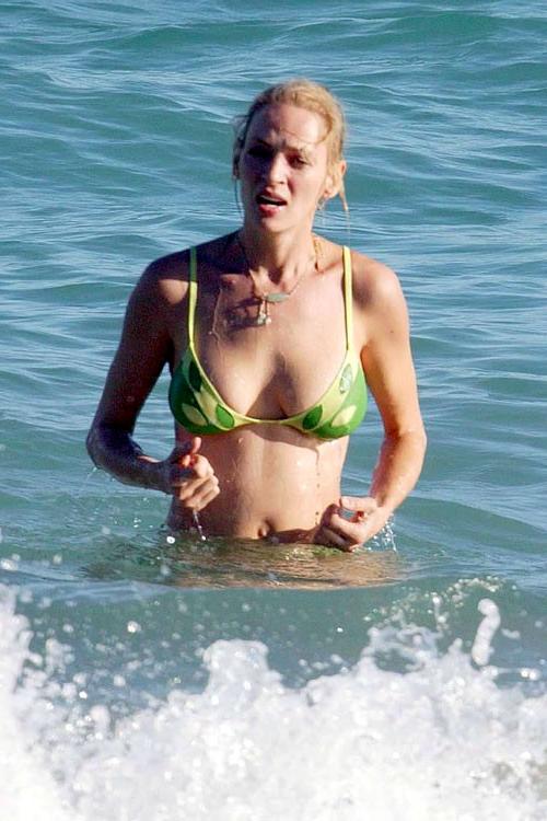 16P Uma Thurman showing her nice big tits on beach and posing in bikini