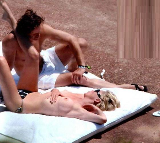 16P Sharon Stone showing her nice big tits on beach paparazzi pictures
