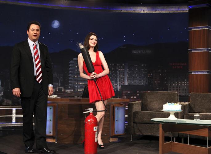 16P Anne Hathaway showing her legs in red mini skirt