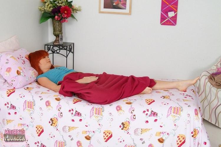 15P A sleeping redhead gets a surprise dildo insertion