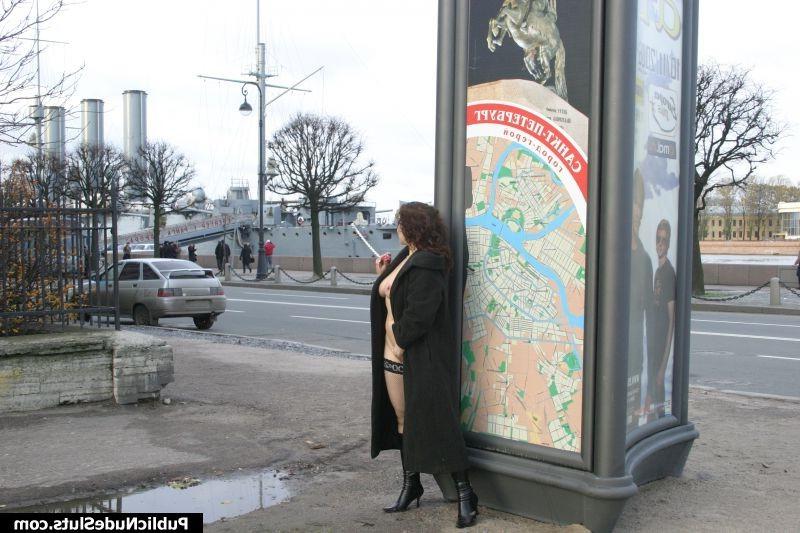 15P Sexy brunette in stockings and coat plays with her pussy in the street