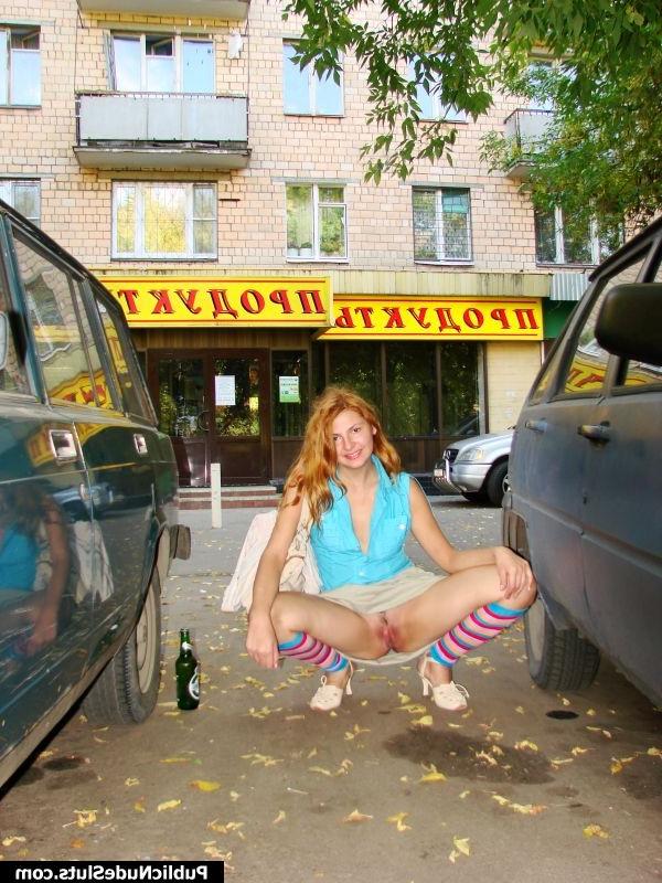 15P Adventurous hotsy has fun showing her titties and pussy in the street