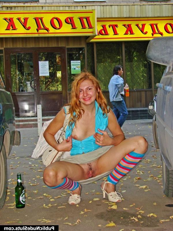 15P Adventurous hotsy has fun showing her titties and pussy in the street