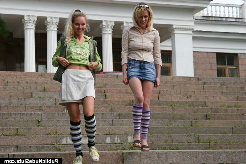 15P Two blonde girls make a parade of their asses in front of a building