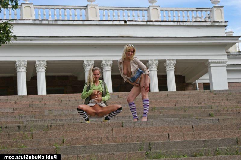15P Two blonde girls make a parade of their asses in front of a building