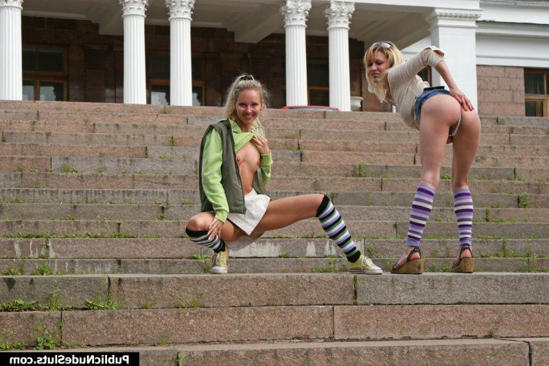 15P Two blonde girls make a parade of their asses in front of a building