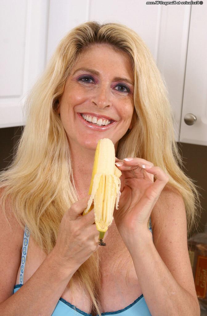 16P A sexy busty blonde mature lady eating a banana