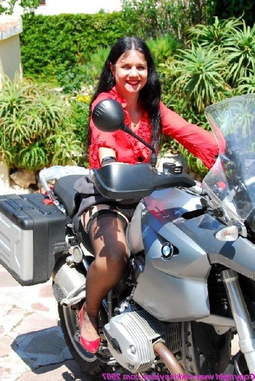 15P Mature Nikki in stockings on a bike