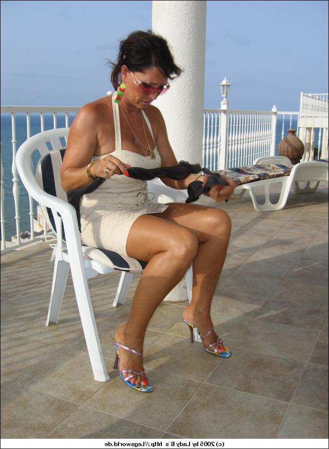 12P Elegant lady in white stripping her tan stockings