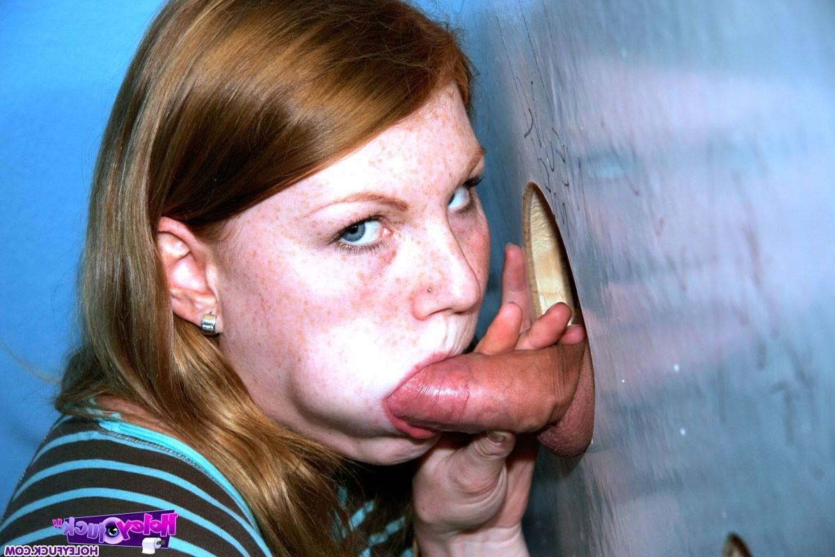 14P Redhead girl enjoys a big surprise erection trough the wall