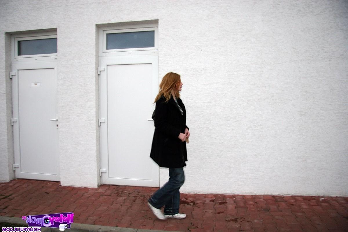 14P Redhead girl enjoys a big surprise erection trough the wall