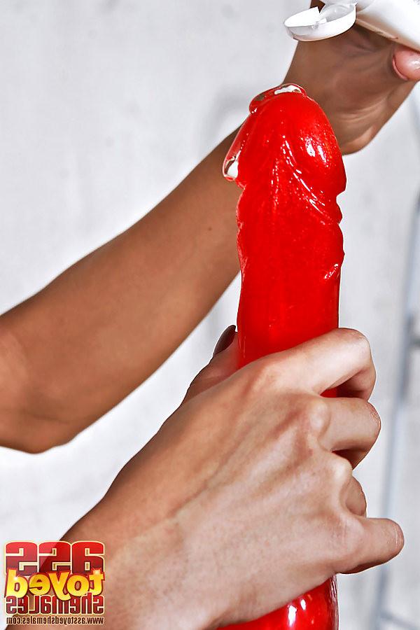 17P tranny stripping and creaming and using a huge red anal dildo