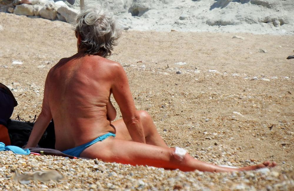 20P grandmother sunbathing on the beach