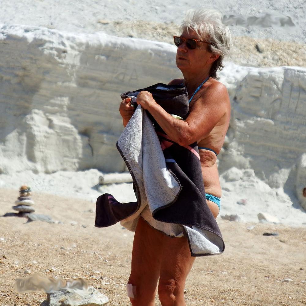 20P grandmother sunbathing on the beach