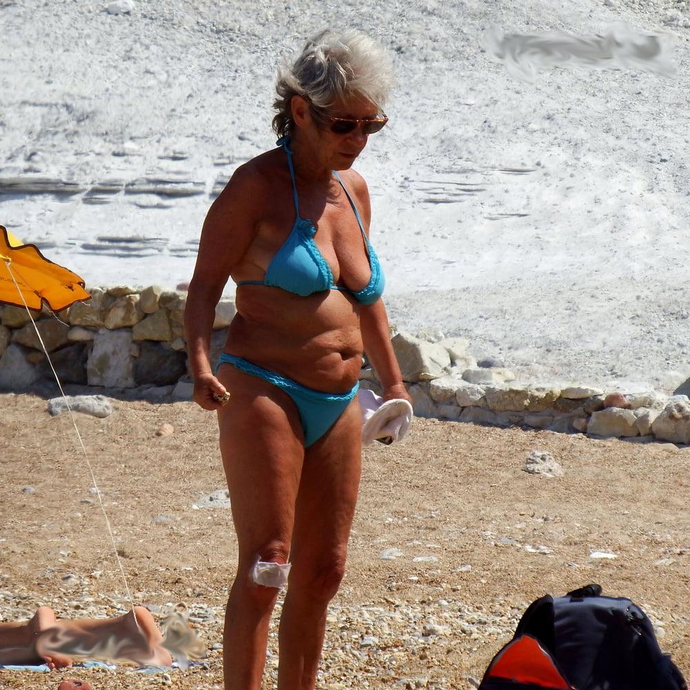 20P grandmother sunbathing on the beach