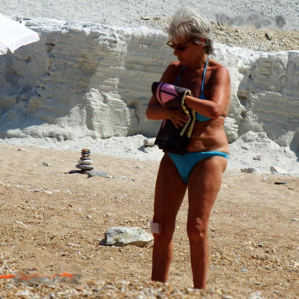 20P grandmother sunbathing on the beach