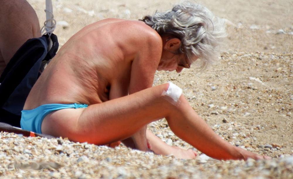 20P grandmother sunbathing on the beach