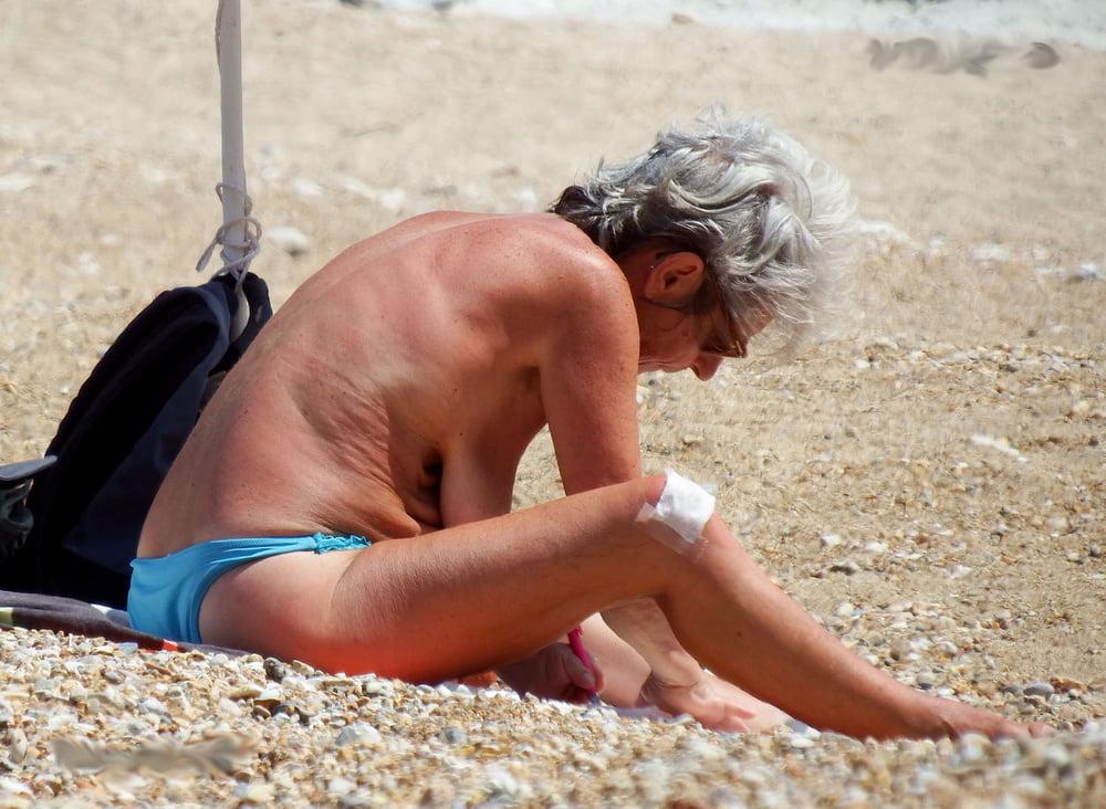 20P grandmother sunbathing on the beach
