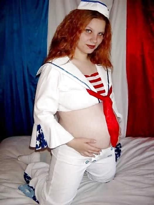 14P Pregnant redhead taking off her sailors uniform