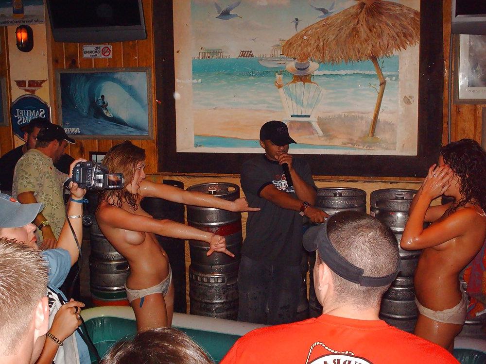 9P Two topless girls play-fighting in a bar