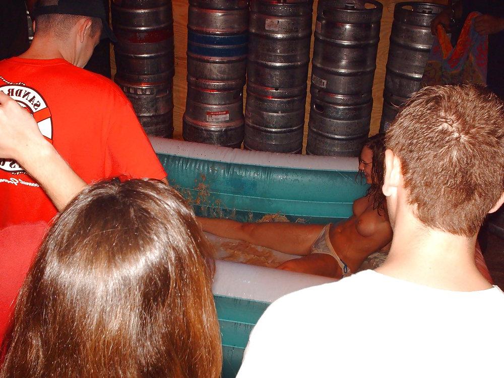 9P Two topless girls play-fighting in a bar