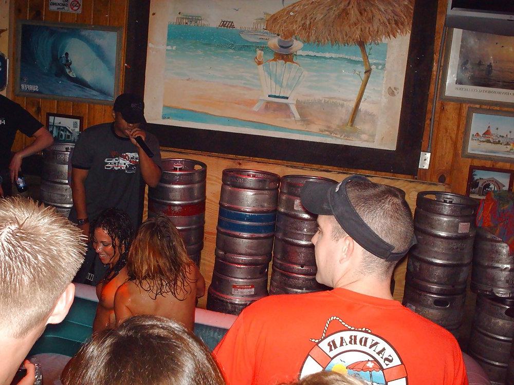 9P Two topless girls play-fighting in a bar