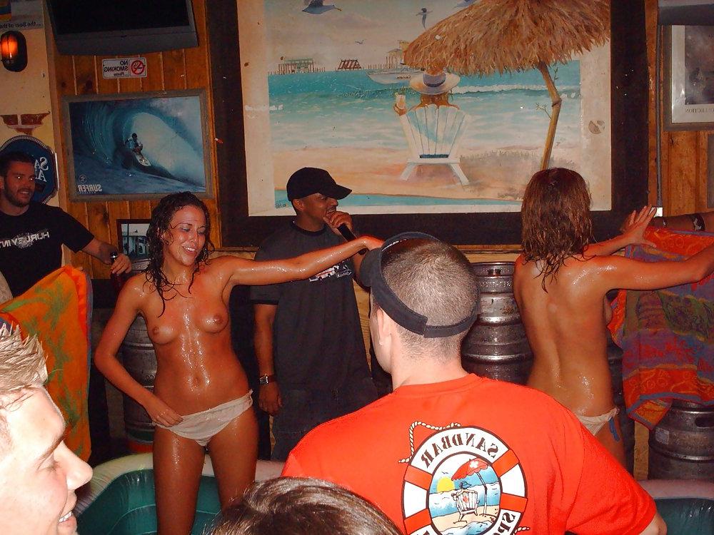 9P Two topless girls play-fighting in a bar