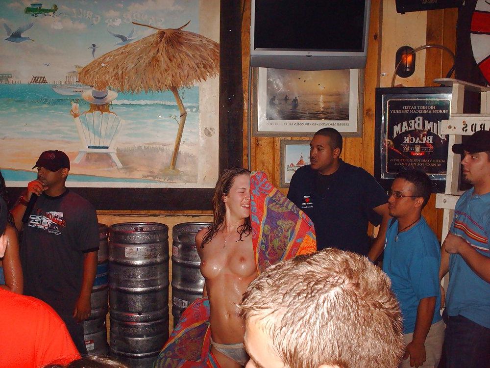 9P Two topless girls play-fighting in a bar