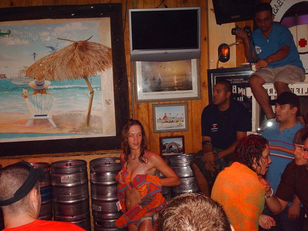9P Two topless girls play-fighting in a bar