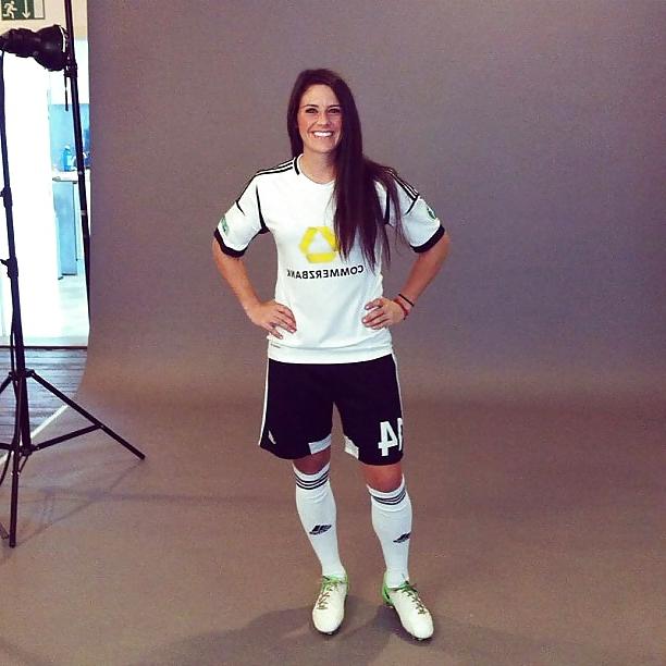 24P Ali Krieger posing in her sports bra