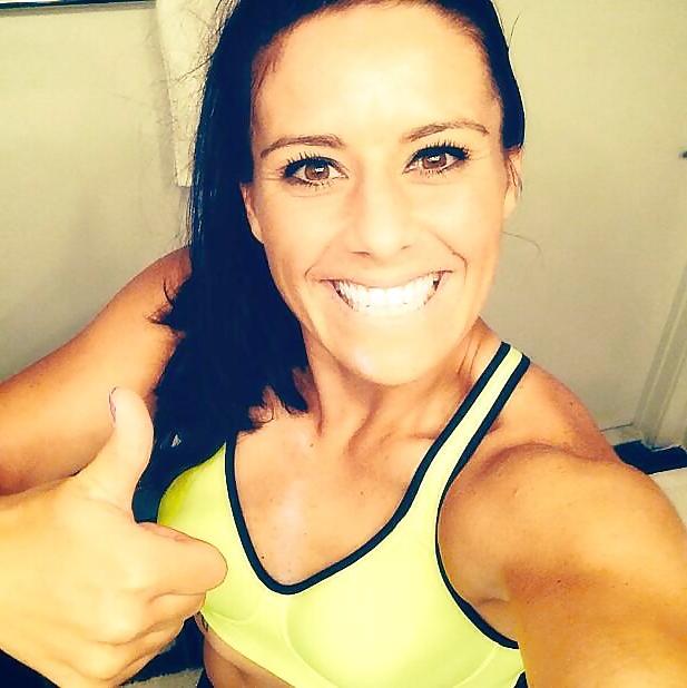 24P Ali Krieger posing in her sports bra