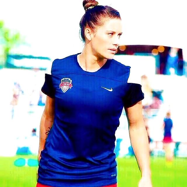 24P Ali Krieger posing in her sports bra