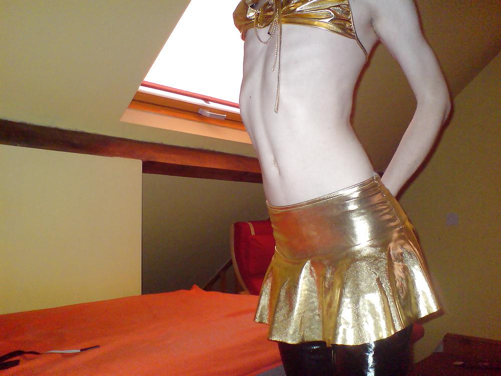 10P Sissy wears a gold mini skirt & bra