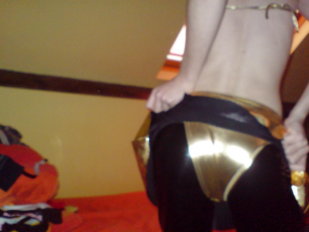 10P Sissy wears a gold mini skirt & bra
