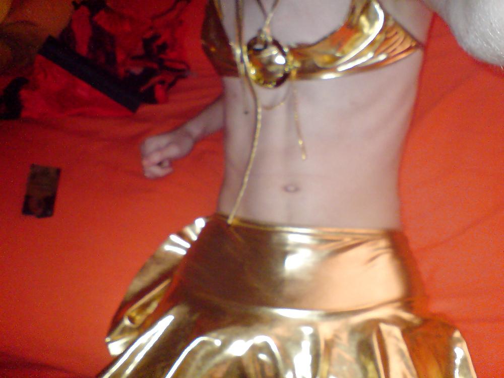 10P Sissy wears a gold mini skirt & bra