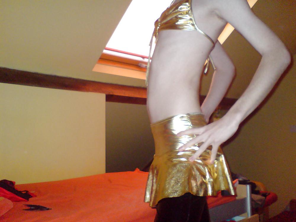 10P Sissy wears a gold mini skirt & bra