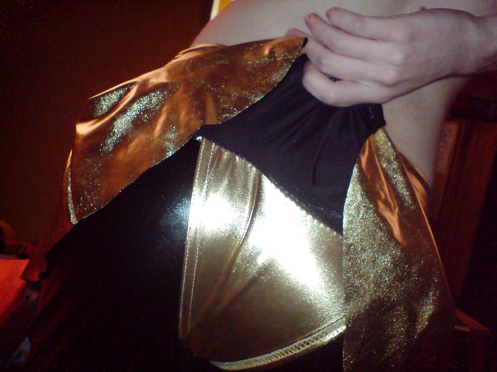 10P Sissy wears a gold mini skirt & bra