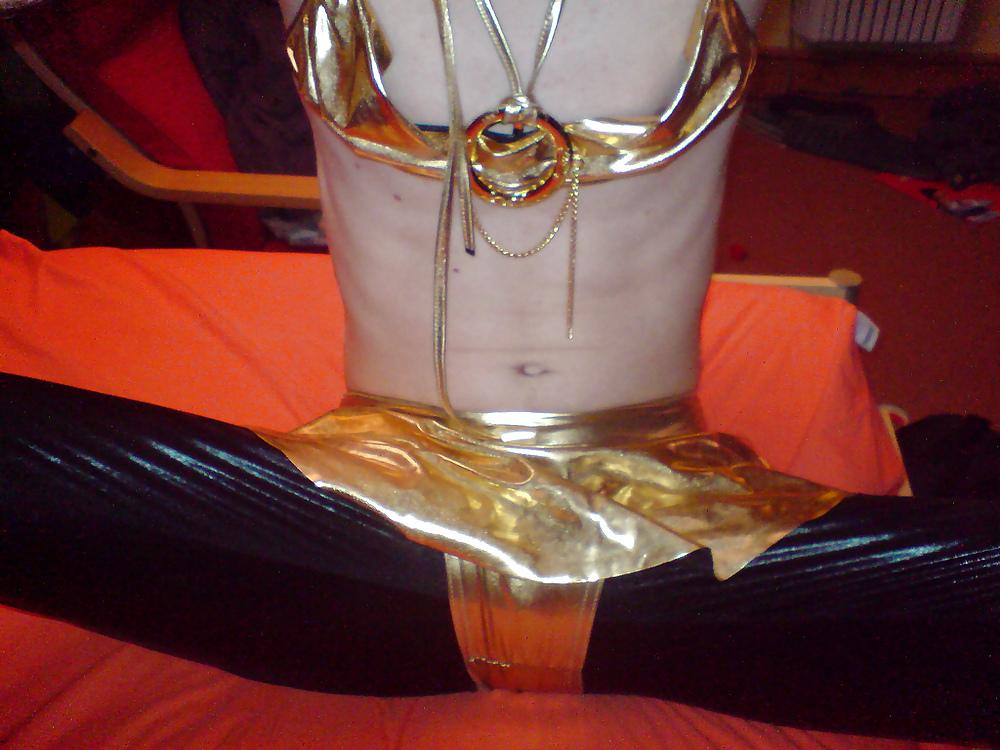 10P Sissy wears a gold mini skirt & bra