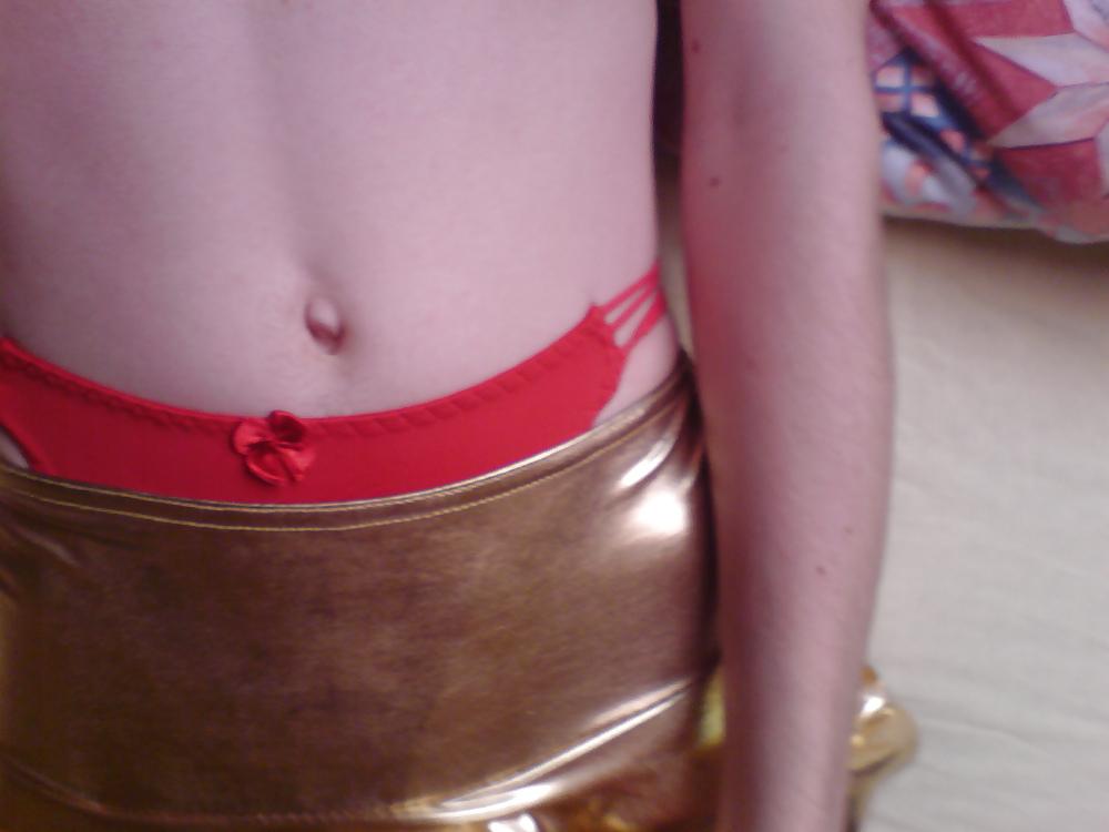 10P Sissy wears a gold mini skirt & bra