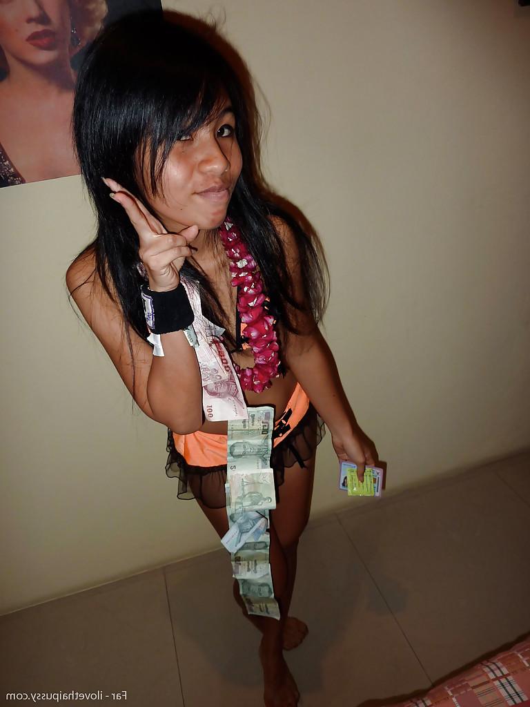 12P Petite Thai bar girl showing off her shaved pussy for money