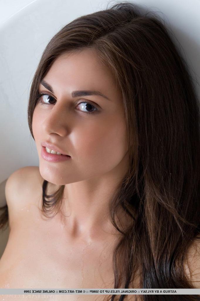 18P Pigtail adorned brunette Astrud A showing off trimmed twat in bathroom