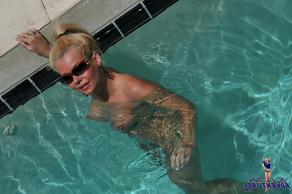 15P Cute blonde MILF Barbi Sinclair shows her fantastic body wearing sexy bikini in the pool.